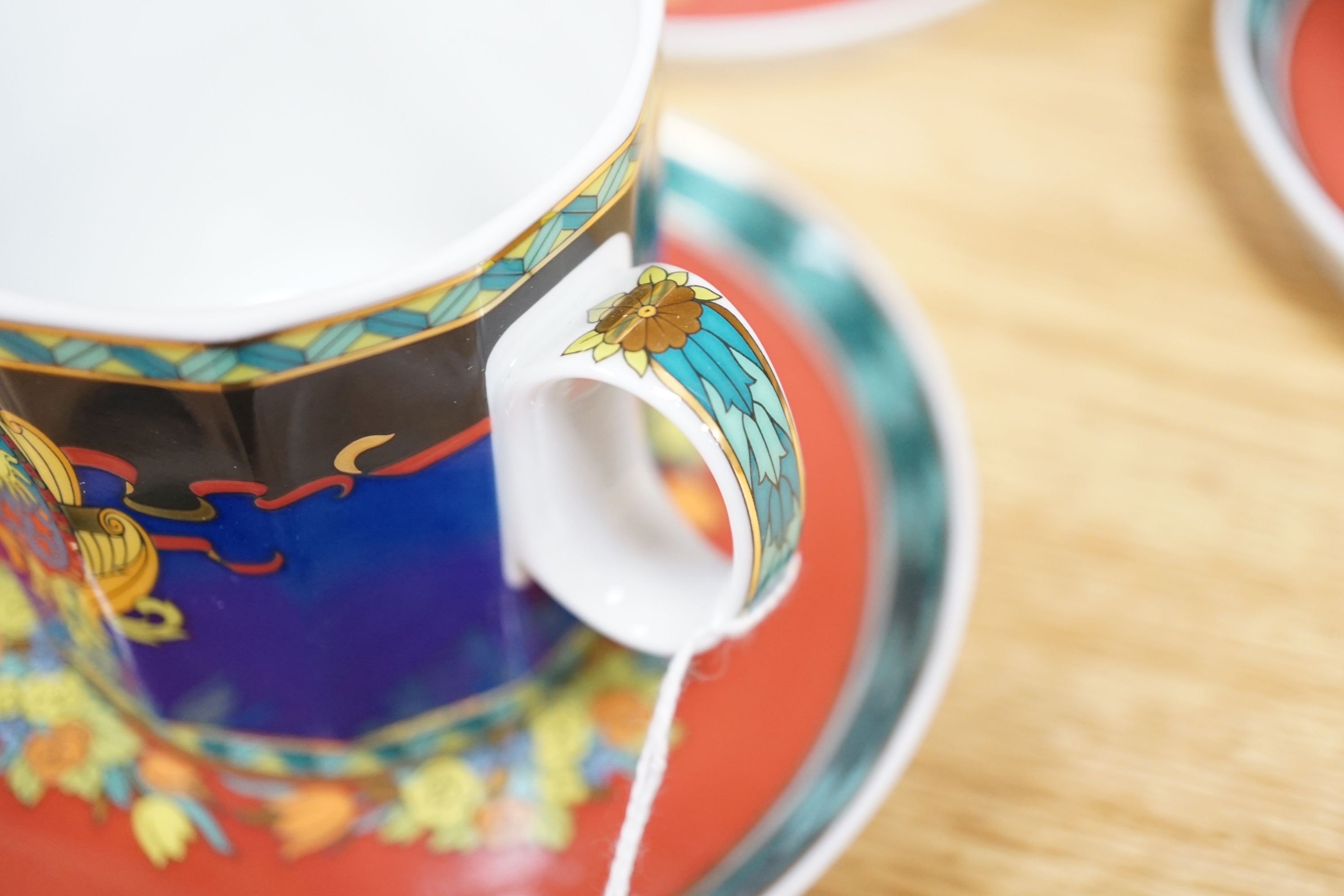 A set of eight Versace 'Le Roi Soleil' pattern cups and saucers